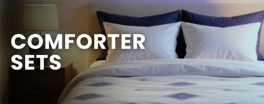 Bed with white and blue comforter set and pillows, text 'COMFORTER SETS' displayed.